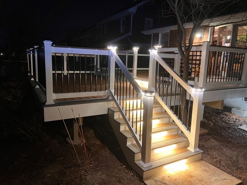 Night view of hardwired deck rail and stair lighting by Bright Ideas Electric
