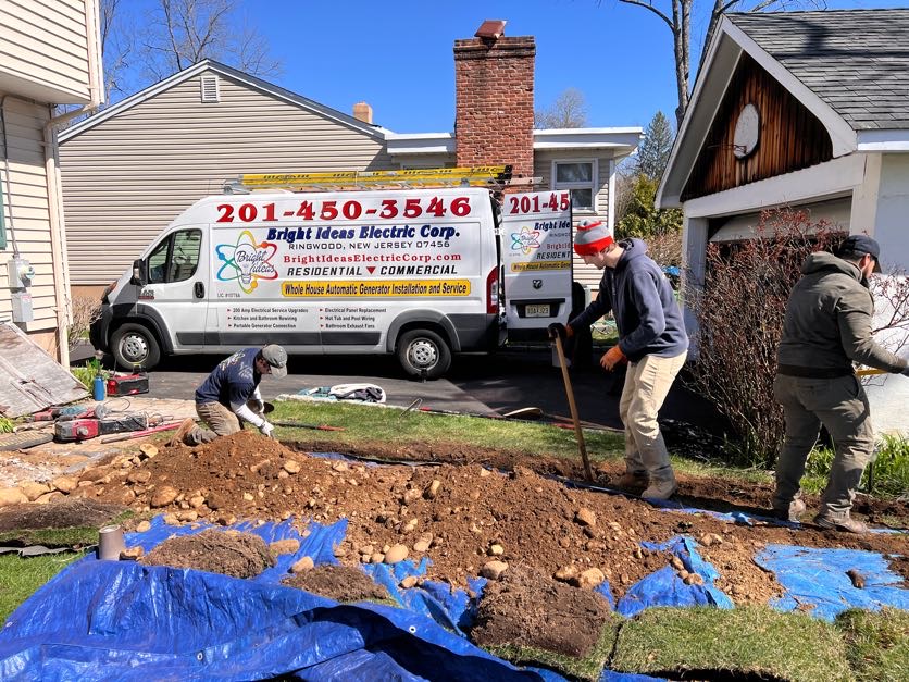 The crew trenching for an underground electrical service with the van on site