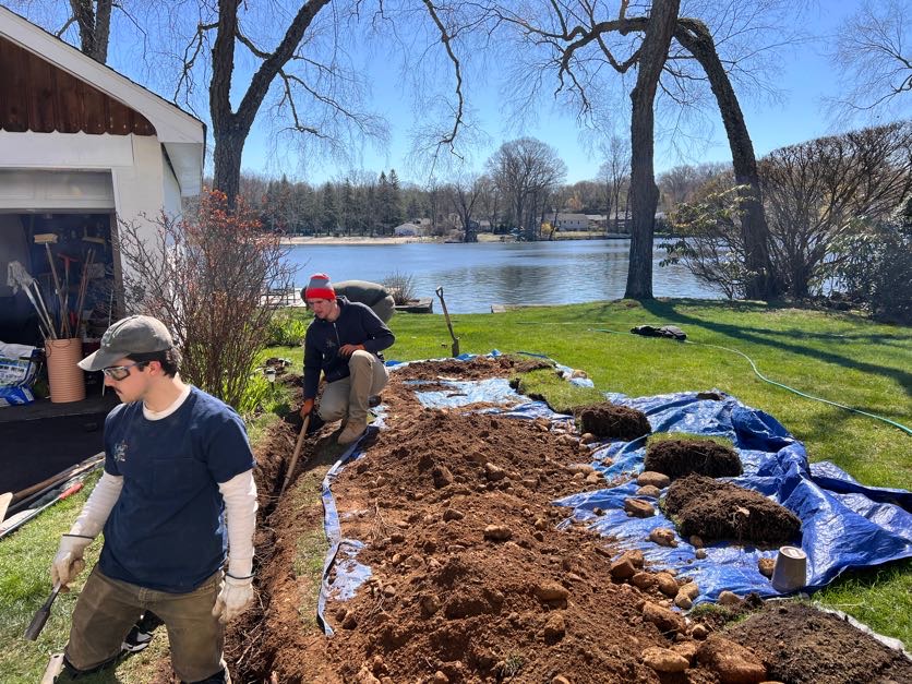 Crew members digging an underground electrical line beside a North Jersey lake