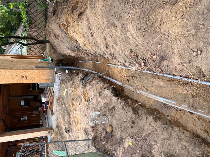 Underground electrical service conduit installed in a trench